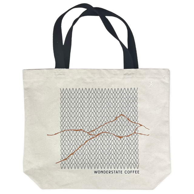 Tote bag with mountain design and 'Wonderstate Coffee' text on a white background